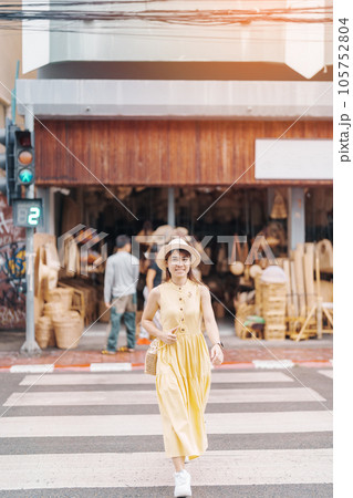 Young asian woman traveler in dress with hat traveling to wicker shop on Chang Moi Kao Road, Tourist visit at the old city in Chang Mai, Thailand. Asia Travel, Vacation and summer holiday concept Young asian woman traveler in dress with hat traveling to wicker shop on Chang Moi Kao Road, Tourist visit at the old city in Chang Mai, Thailand. Asia Travel, Vacation and summer holiday concept 105752804