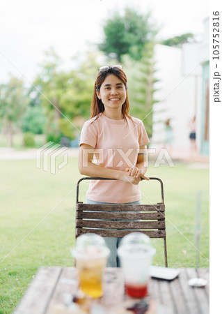 Happy woman with Dessert in cafe, young Asian girl smiling during eating cake and drinking ice beverage at home Happy woman with Dessert in cafe, young Asian girl smiling during eating cake and drinking ice beverage at home 105752816