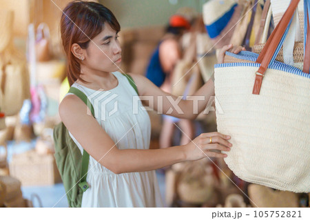 woman hand holding handcraft basket in wicker shop, Tourist visit at the old city in Chang Mai, Thailand. Asia Travel, Vacation and summer holiday concept 105752821
