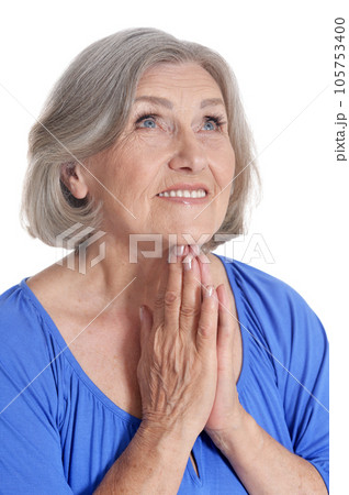 senior woman praying isolated on white background 105753400