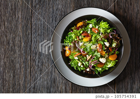 Mandarin Orange Salad in black bowl, top view 105754391
