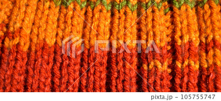 Handmade knitted fabric orange and red wool background texture Handmade knitted fabric orange and red wool background texture 105755747