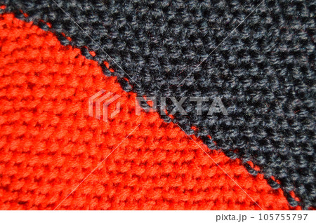 Handmade knitted fabric red and black wool background texture 105755797
