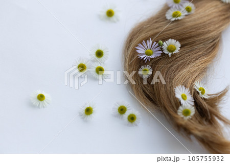 Hair with flowers. Closeup, selective focus. Hair with flowers. Closeup, selective focus. 105755932