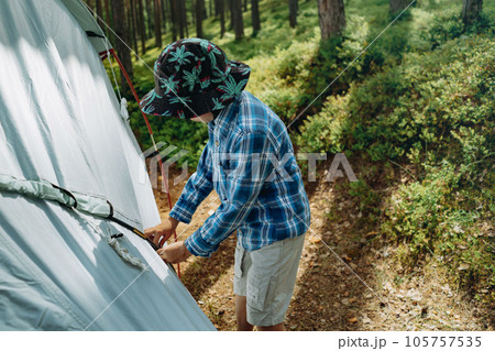 cute little caucasian boy putting up a tent. Family camping concept 105757535
