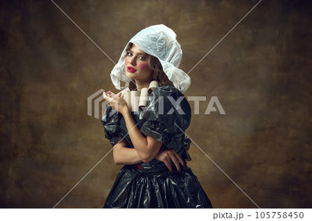 Queen. Portrait of elegance woman wearing white plastic hat, black dress made of garbage bags and paper tube necklace. Queen. Portrait of elegance woman wearing white plastic hat, black dress made of garbage bags and paper tube necklace. 105758450