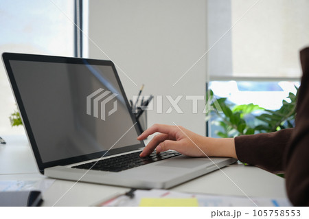 Closeup view female entrepreneur searching online information on laptop, working with reports at office Closeup view female entrepreneur searching online information on laptop, working with reports at office 105758553