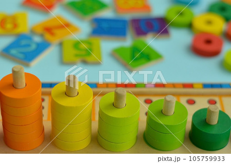 Math game for children. Natural materials, wooden. Score, number composition. Home education concept, early development, skills. Daylight. Outside. Math game for children. Natural materials, wooden. Score, number composition. Home education concept, early development, skills. Daylight. Outside. 105759933