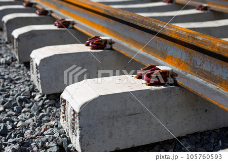 Anchor intermediate rail fastenings. Modern fastening of rails to a sleeper on a railway track Anchor intermediate rail fastenings. Modern fastening of rails to a sleeper on a railway track 105760593