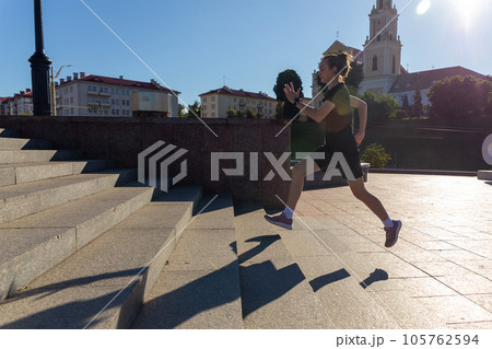 A young woman in black clothes running on stairs 105762594