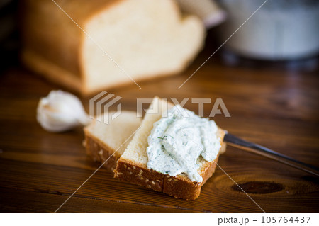 homemade salted curd spread with herbs and garlic 105764437