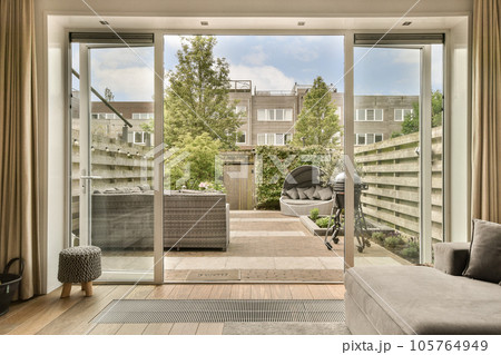 a living room with sliding glass doors that open up to the patio and backyard area in front of the house a living room with sliding glass doors that open up to the patio and backyard area in front of the house 105764949