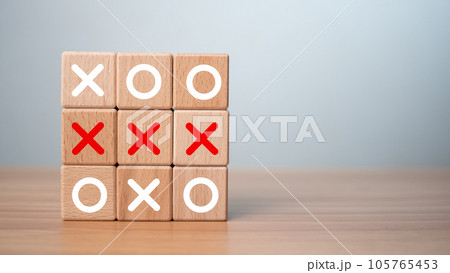 Tic Tac Toe game made of wooden blocks. Front view of wooden OX game on wooden table.Business marketing strategy planning concept. Business competitor assessment concept. 105765453