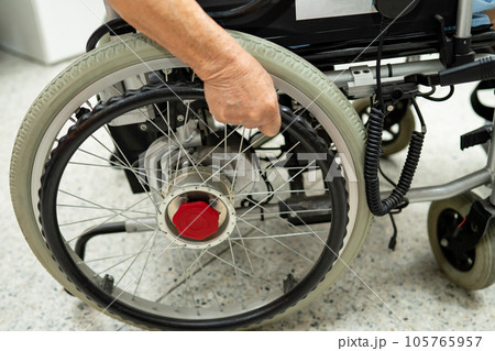 Asian senior woman patient on electric wheelchair with remote control at hospital, healthy strong medical concept. 105765957