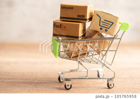 Bangkok, Thailand September 26, 2022 Shopping cart with DHL Amazon and FedEx express packing box, import export online exchange investment business. 105765958