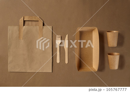 Eco friendly disposable tableware. Biodegradable craft dishes. Recycling concept. Also used in fast food, restaurants, takeaways, picnics. Close-up. Eco friendly disposable tableware. Biodegradable craft dishes. Recycling concept. Also used in fast food, restaurants, takeaways, picnics. Close-up. 105767777