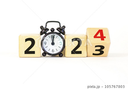 Business concept of 2024 new year symbol. Businessman turns a wooden cube and changes number 2023 to 2024. Black alarm clock. Beautiful white background, copy space. 2024 happy new year concept. 105767803