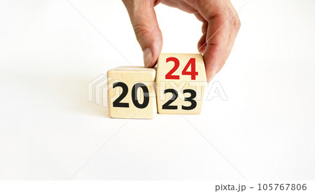 Business concept of 2024 new year symbol. Businessman turns a wooden cube and changes number 2023 to 2024. Businessman hand. Beautiful white background, copy space. 2024 happy new year concept. 105767806