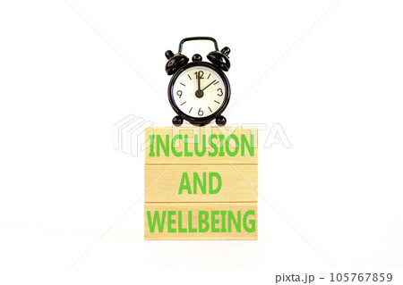 Inclusion and wellbeing symbol. Concept words Inclusion and wellbeing on wooden block. Beautiful white table white background. Black alarm clock. Motivational inclusion wellbeing concept. Copy space. 105767859