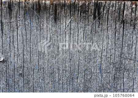 The surface of old rotten boards. Cracks in the wood. Old plywood. Traces of paint. The surface of old rotten boards. Cracks in the wood. Old plywood. Traces of paint. 105768064