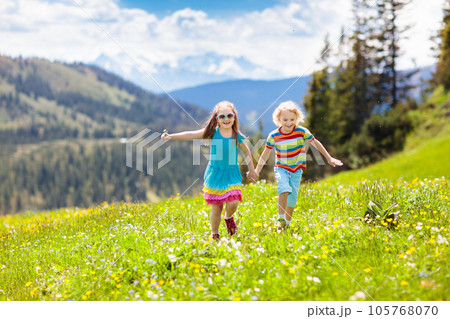 Children hiking in Alps mountains. Kids outdoor. Children hiking in Alps mountains. Kids outdoor. 105768070