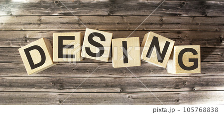 DESIGN word written on a wooden block. DESIGN text on wooden table for your design, concept DESIGN word written on a wooden block. DESIGN text on wooden table for your design, concept 105768838