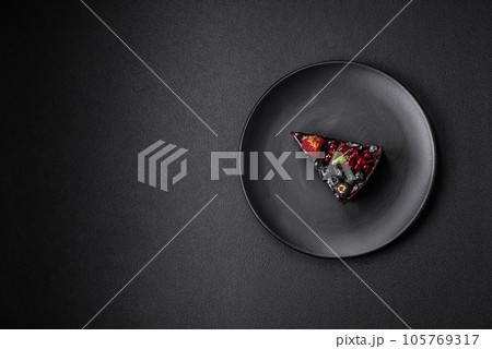 Delicious sweet chocolate brownie cake with blueberries, currants and raspberries Delicious sweet chocolate brownie cake with blueberries, currants and raspberries 105769317