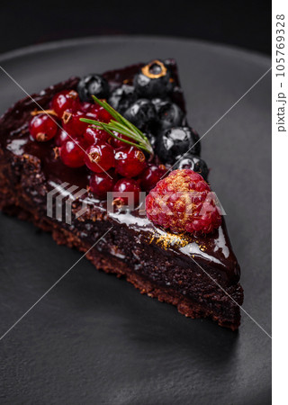 Delicious sweet chocolate brownie cake with blueberries, currants and raspberries Delicious sweet chocolate brownie cake with blueberries, currants and raspberries 105769328