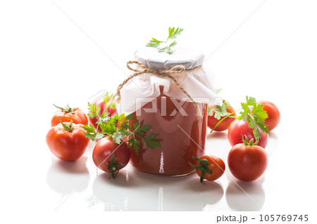 Cooked homemade tomato juice canned in a jar of natural tomatoes. 105769745