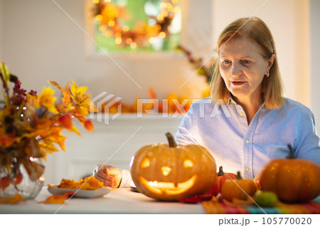 Family carving pumpkin for Halloween 105770020
