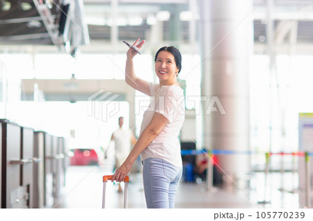 Young Asian woman in airport. Travel by air. Young Asian woman in airport. Travel by air. 105770239