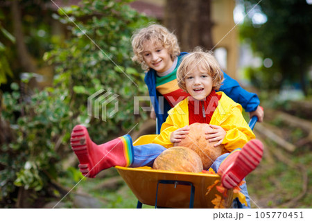 Kids on pumpkin patch. Child autumn outdoor fun. 105770451