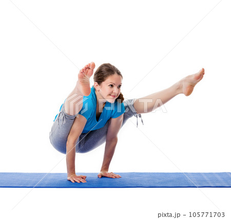 Yoga - young beautiful woman yoga instructor doing Firefly asana pose (Titibasana) exercise isolated on white background 105771703