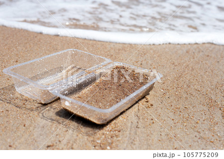 Plastic food container on the beach 105775209