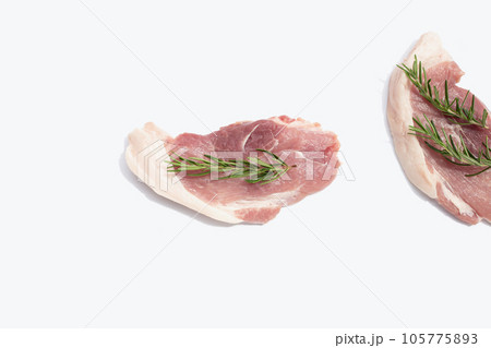 Pork meat with rosemary on white background. 105775893