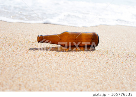 Glass bottle on the beach 105776335