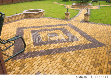 paved with tiles path in the Park. Paving slabs and lanterns in a park on a sunny day. paved with tiles path in the Park. Paving slabs and lanterns in a park on a sunny day. 105777241