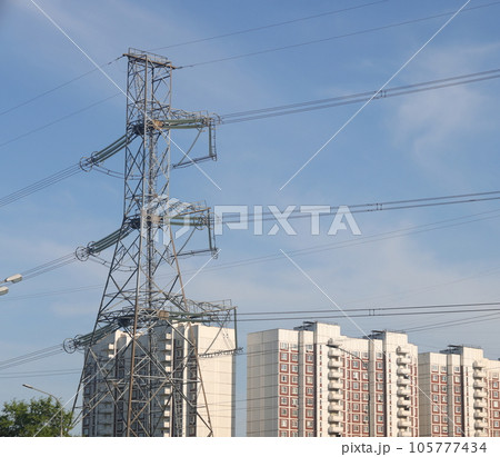 High voltage power lines and pylons in the city. Power lines against the background of buildings 105777434