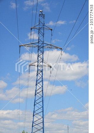 Photo of an electric tower against a blue sky. high voltage post. High voltage tower  105777438