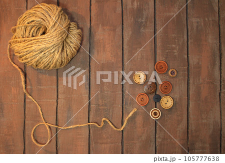 jute twine with buttons on brown boards. Copy space jute twine with buttons on brown boards. Copy space 105777638
