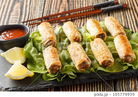 Vietnamese nems or deep fried spring rolls with chicken closeup on the plate. Horizontal 105779939
