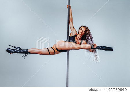 Young woman pole dancing 105780849