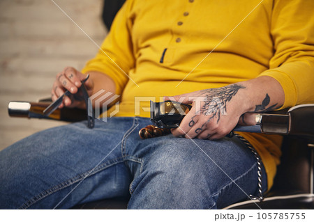 Stylish barber man with hairdressing tools in his hands prepare for work 105785755