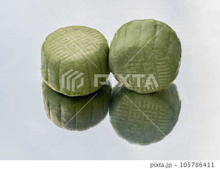 Delicious two green mooncake is filled with taro, black sesame and golden thread egg which are reflected on white background. Delicious two green mooncake is filled with taro, black sesame and golden thread egg which are reflected on white background. 105786411