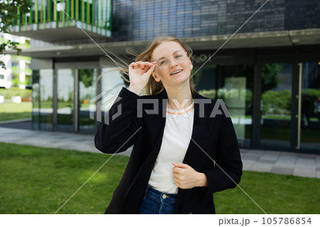 Portrait of successful woman in urban background. Business people concept Portrait of successful woman in urban background. Business people concept 105786854