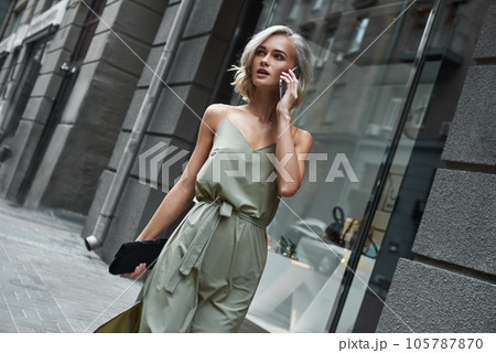 Fashion. Young stylish woman walking on the city street Fashion. Young stylish woman walking on the city street 105787870
