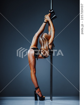 Young woman pole dancing 105789497