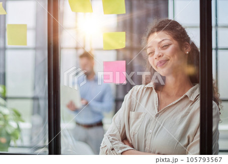 Smiling business woman looking out the window. 105793567