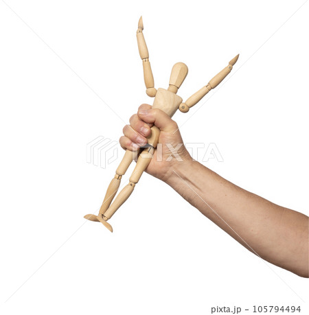 a small wooden dummy in a man's hand a small wooden dummy in a man's hand 105794494