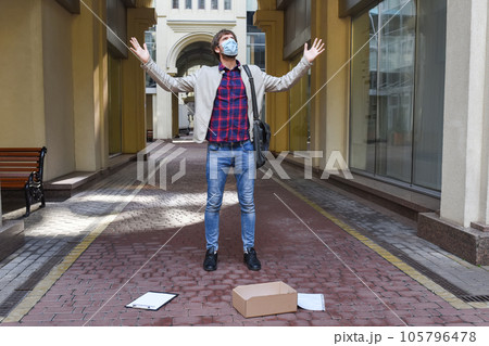 Emotional office worker wearing a protective mask fired from his job due to the global economic crisis 105796478